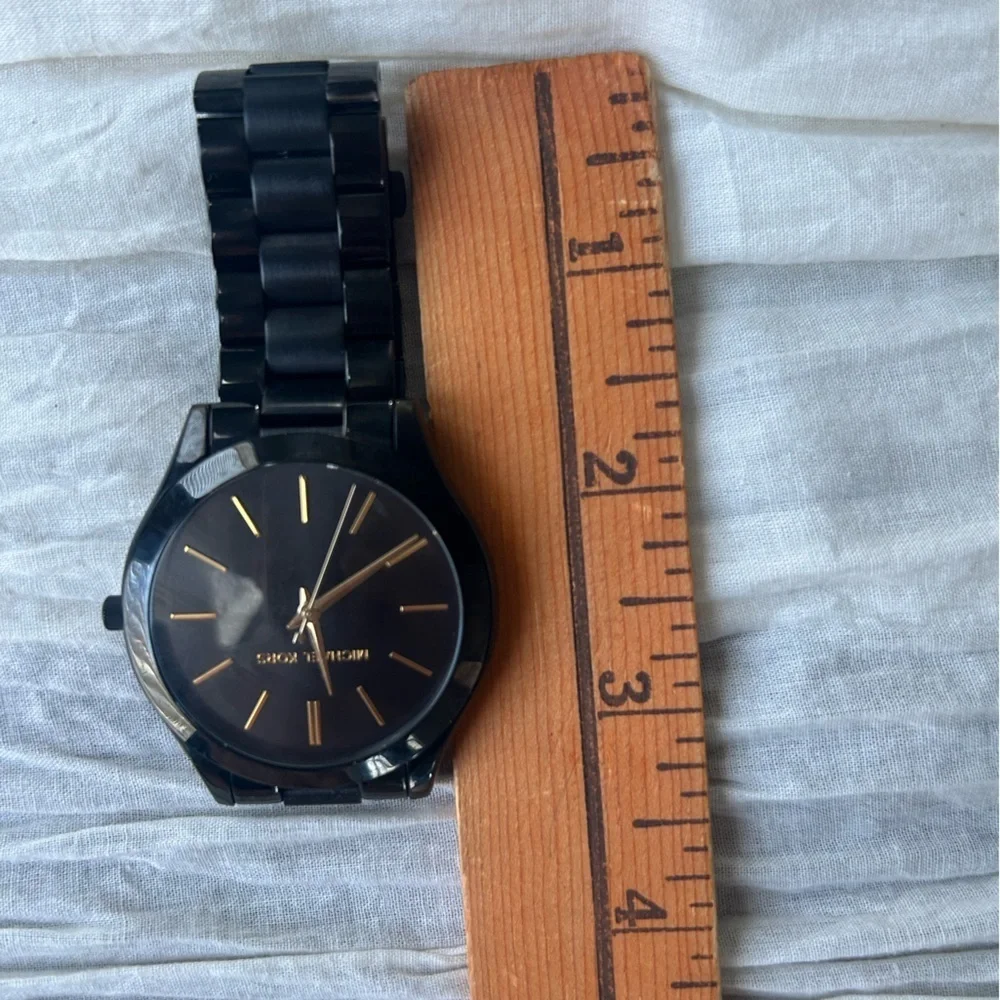 Michael Kors Black and Gold Watch It needs a battery replacement.